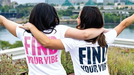 Paloma Founders Alyssa Varela McKee and Jana Chapman pose in front of the Portland skyline.
